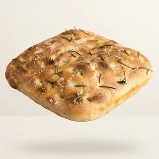 A square slab of sourdough focaccia, dimpled and golden, scattered with rosemary and flakes of sea salt.